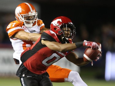Calgary Stampeders Ciante Evans, right, intercepts a pass to BC Lions Marco Iannuzzi during CFL action at McMahon Stadium in Calgary, Alta.. on Friday July 29, 2016.