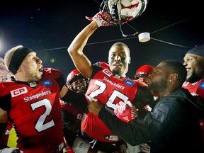 Calgary Stampeders Tommie Campbell celebrates with teammates after his interception in the endzone in overtime for a 44-41 win over the BC Lions in CFL football in Calgary, Alta., on Friday, July 29, 2016.