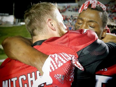 Calgary Stampeders Tommie Campbell celebrates with Bo Levi Mitchell after his interception in the endzone in overtime for a 44-41 win over the BC Lions in CFL football in Calgary, Alta., on Friday, July 29, 2016. AL CHAREST/POSTMEDIA