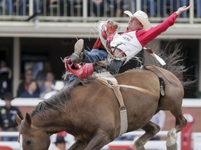 Steven Peebles of Redmond, Ore., rides Sourdough to the day's best score in bareback riding on Day 5 of the Calgary Stampede Rodeo in Calgary, Alta., on Tuesday, July 12, 2016. Cowboys compete for 10 days for a piece of the rodeo's $2 million in prize money. Lyle Aspinall/Postmedia Network