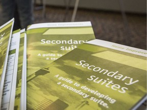 Crystal Schick/ Calgary Herald CALGARY, AB -- Attendees get information about secondary suites at an open house at Killarney community hall in Calgary, on March 1, 2015. --