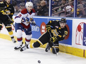 Brandon's Kale Clague (10) passes under pressure from Edmonton's Brett Pollock (39) during the first period of a WHL playoff game between the Edmonton Oil Kings and the Brandon Wheat Kings at Rexall Place in Edmonton, Alta., on Sunday April 3, 2016. Photo by Ian Kucerak