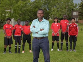 Jean-Claude Munyezamu poses with players from his CalGlen Dynamos U-14 soccer team. Players left to right: Siem Ghebre, 12, Mayen Dut, 12, Fiston Mgelelo, 13, Jose Moreno, 13, Spiro Kajusa, 14, and Moneer Mehalhel, 13.