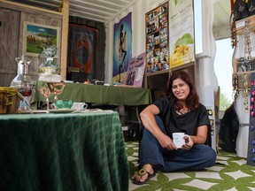 Zahra Karmali poses inside her shipping container turned community project store with a cup of TAK tea on 17th Avenue S.E. in Calgary, Alta., on Thursday, July 28, 2016.