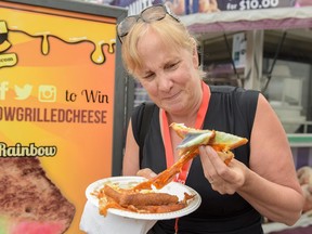 Valerie Fortney inspects a fruit-infused grilled cheese at the 2016 Calgary Stampede in Calgary, Alta., on Saturday, July 9, 2016.