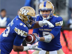 Winnipeg Blue Bombers QB Drew Willy hands off to RB Andrew Harris during CFL action against the Edmonton Eskimos in Winnipeg on Thu., July 14, 2016. Kevin King/Winnipeg Sun/Postmedia Network