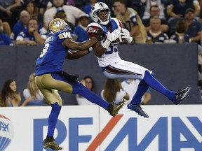 Montreal Alouettes' Duron Carter (89) can't hang onto the ball as Winnipeg Blue Bombers' Chris Randle (8) defends during the first half of CFL action in Winnipeg Friday, June 24, 2016.
