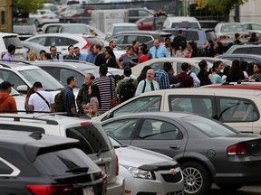 Hundreds of people line up outside Coast Plaza Hotel in Calgary, Alta., on Wednesday August 17, 2016, during the Calgary Airport Authorities job fair to find workers for when they open the new terminal. Leah Hennel/Postmedia