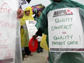Support staff at Monterey Place walk the picket line after being looked out by management in Calgary, Alberta on June 26, 2012.