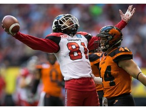 Calgary Stampeders' Bakari Grant, left, celebrates his touchdown as B.C. Lions' Adam Bighill walks past during the first half of a CFL football game in Vancouver, B.C., on Friday August 19, 2016.