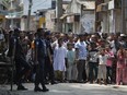 Bangladeshis gather near a shooting scene in Narayanganj, outskirts of Dhaka, Saturday, Aug. 27, 2016. Police in Bangladesh say they have killed three suspected militants, including Tamim Chowdhury, a Bangladeshi-born Canadian, who police believe was one of two masterminds of the attack on a popular restaurant in Dhaka.