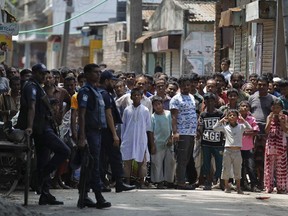 Bangladeshis gather near a shooting scene in Narayanganj, outskirts of Dhaka, Saturday, Aug. 27, 2016. Police in Bangladesh say they have killed three suspected militants, including Tamim Chowdhury, a Bangladeshi-born Canadian, who police believe was one of two masterminds of the attack on a popular restaurant in Dhaka.