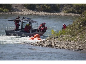 CALGARY, AB -- Calgary Fire Rescue teams were searching for, and cleaning up pieces of rebar in the Bow River near Crowchild in Calgary, on August 16, 2016. Over the weekend, rafters were getting sunk and stranded after their rafts were popped by the perturbing metal. --  (Crystal Schick/Postmedia) (For City story by  )