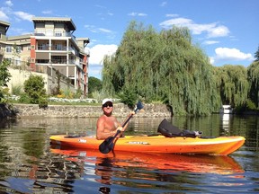 Calgarian Jim Lynn, kayaking, and his wife Marianne bought a condo at Water's Edge in Kelowna to enjoy Okanagan summers.