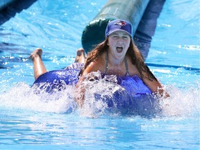 Calgarians beat the heat as they try out the 250 metre long waterslide at WinSport in Calgary on Sunday August 20, 2016.