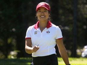 Calgarian Jaclyn Lee is all smiles after her shot from the first tee during round 2 of the Canadian Pacific Women's Open at Priddis Greens Golf and Country Club west of Calgary, Alta.,  August 26, 2016. Leah Hennel/Postmedia