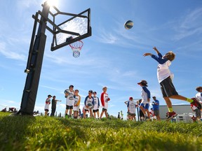 Kids practice shooting hoops before a basketball game at the second annual Nathan O'Brien Superhero Sports Decathlon at Springbank Park west of Calgary on Sunday August 20, 2016. Gavin Young/Postmedia