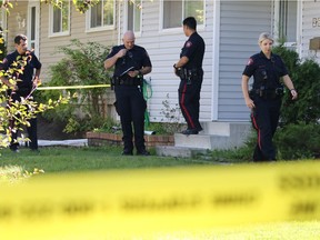 Police investigate at a home on Huntcroft Road N.E. in Calgary following an early morning double stabbing on Monday August 15, 2016. Gavin Young/Postmedia