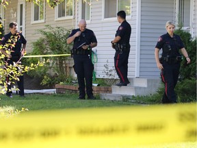 Police investigate at a home on Huntcroft Road N.E. in Calgary following an early morning double stabbing on Monday August 15, 2016.