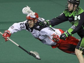 Calgary Roughnecks Tyler Digby decked by Saskatchewan Rush Ryan Dilks in NLL action at the Scotiabank Saddledome in Calgary, Alta. on Saturday, May 14, 2016. The Rush beat the Roughnecks 16-10. Mike Drew/Postmedia