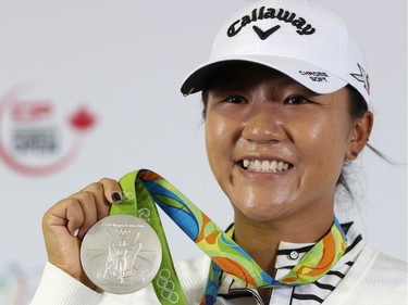 Olympian Lydia Ko shows off her silver medal from Rio Olympics to members of the media after the Pro-Am at Priddis Greens Golf and Country Club west of Calgary, Alta., on Wednesday August 24, 2016.