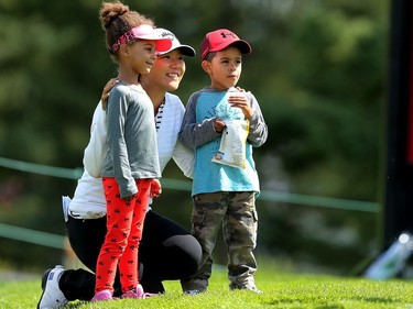 Olympic silver medalist Lydia Ko poses for a photo with young fans Aleah Rodipe, 5, and her brother Kobey during the Pro-Am at Priddis Greens Golf and Country Club west of Calgary, Alta., on Wednesday August 24, 2016.