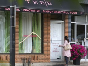 A former customer reads the closure notice on the door of Red Tree Catering in Marda Loop Wednesday August 10, 2016. It is one of many Calgary businesses that have closed since the start of the recession.