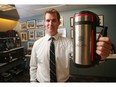 Tim Mowrey, manager of administration services with the City clerk's office, holds up a city-branded traveling thermos Thursday August 11, 2016 in the gift room at Calgary City Hall.