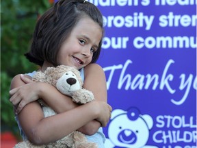 Payton Langenau, 6, holds a teddy bear during a presentation at Alberta Children's Hospital Aug. 15, 2016 in Calgary. ATB Financial raised $800,000 for both Alberta children's hospitals in its 17th annual Teddy for a Toonie campaign this year.