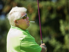 John Daly enjoys a smoke while working on his short game during practice day as the big names arrive for the Shaw Charity Classic at Canyon Meadows Golf Club Tuesday August 30, 2016. (Ted Rhodes/Postmedia)