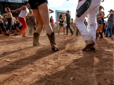 Dancers kick up the dust as Dustin Lynch performs at day 3 of Country Thunder at Prairie Winds Park in Calgary, Ab., on Sunday August 21, 2016. Mike Drew/Postmedia