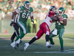 Calgary Stampeders defensive lineman Charleston Hughes (39) tackles Saskatchewan Roughriders quarterback Darian Durant (4) during the second half CFL football action in Regina on Aug. 13, 2016.