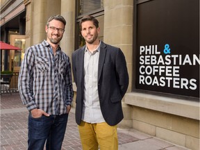 Phil Robertson and Sebastian Sztabzyb stand where the future patio of their sixth namesake Phil & Sebastian Coffee Roasters will be in Calgary. The new location, at the corner of Centre St and 8th Avenue SW, is to open this winter.