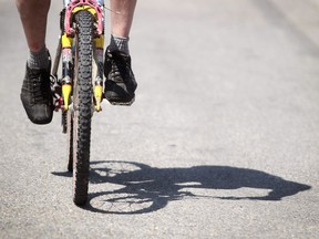 Leah Hennel, Calgary Herald CALGARY, AB.: JUNE 10, 2011 -- Paul Elliott's shadow as he hits the bike paths of downtown Calgary, Alberta, on June 10, 2011. (Leah Hennel, Calgary Herald) (For the history of the city by Jason Markusoff)