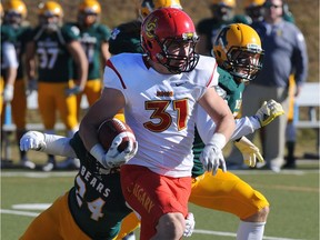 EDMONTON, ALTA: OCTOBER 18, 2014 -- University of Calgary Dinos #31 Quentin Chown on the run against the University of Alberta Golden Bears during football action at Foote Field in Edmonton, October 18, 2014. (ED KAISER/EDMONTON JOURNAL)