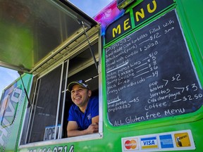 Emmanuel Guardado, who owns the QueChivo Salvadoran food truck, with his vehicle at a park in Calgary, Alta., Friday, Aug. 19, 2016. Guardado had always dreamed of starting his own food business, but it was only when he lost his job in the oil and gas industry that he decided to dive in.