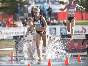 Erin Teschuk (C) leads Maria Bernard (R) and Genevieve Lalonde through the water barrier in the final lap during senior women's 3000m steeplechase final at the Canadian Track and Field Championships and Selection Trials for the 2016 Summer Olympic and Paralympic Games, in Edmonton, Alta., on July 8, 2016.