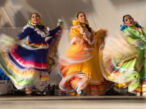 The Mexico pavilion dancers quickly swing their brightly coloured dresses as part of their dance routine at Globalfest 2016 at Elliston Park in Calgary, on August 24, 2016.