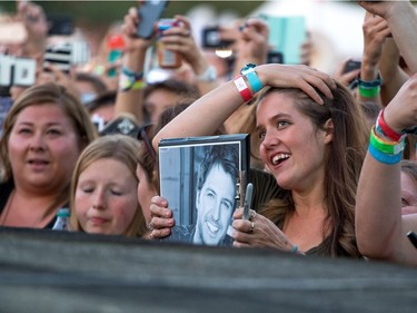 Happy Luke Bryan fans look on as he walks the catwalk at day 3 of Country Thunder at Prairie Winds Park in Calgary, Ab., on Sunday August 21, 2016. Mike Drew/Postmedia