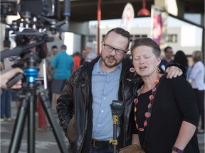 CALGARY, AB -- Andrew and Cynthia Nilsson sing The Tragically Hip song Courage in a tribute video to Gord Downie at the Saddledome in Calgary, on August 3, 2016. --  (Crystal Schick/Postmedia)