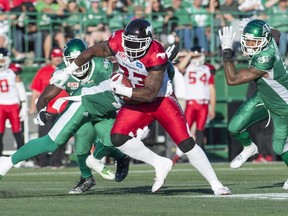 Calgary Stampeders running back Jerome Messam (33) runs the ball against the Saskatchewan Roughriders during the second half CFL football action in Regina on Saturday, August 13, 2016.