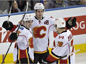 Calgary Flames' Johnny Gaudreau (13), Sean Monahan (23) and Micheal Ferland (79) celebrate a goal against the Edmonton Oilers during third period NHL action in Edmonton, Alta., on Saturday April 2, 2016.