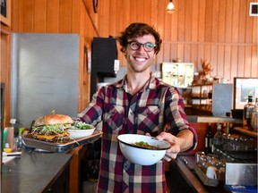 Kyle is ready with a burger, and beans and cornbread at Camp Cookhouse.