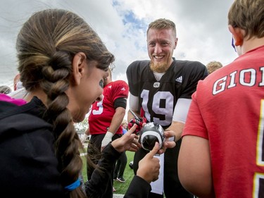 Calgary Stampeders quarterback Bo Levi Mitchell signs autographs for Make-A-Wish Foundation kids after a Calgary Stampeders practice in Calgary, Alta., on Thursday, Aug. 25, 2016. About 30 kids with the Make-A-Wish Foundation of Southern Alberta watched a team practice, toured the Stampeders' locker room and met the players. Lyle Aspinall/Postmedia Network