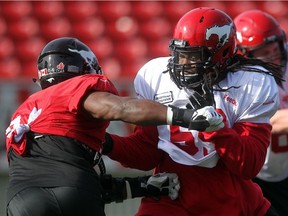 Calgary Stampeders offensive lineman Randy Richards, right, challenges defensive lineman Frank Beltre during practice at McMahon Stadium on October 6, 2015.