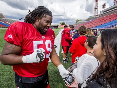 Randy Richards signs autographs for Make-A-Wish Foundation kids after a Calgary Stampeders practice in Calgary, Alta., on Thursday, Aug. 25, 2016. About 30 kids with the Make-A-Wish Foundation of Southern Alberta watched a team practice, toured the Stampeders' locker room and met the players. Lyle Aspinall/Postmedia Network
