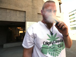 Gord Haze medicates with a vaporizer outside the opening of Lift Resource Centre in Calgary on Tuesday, August 16, 2016.