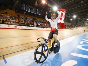 Canada's Monique Sullivan celebrates her gold medal win following the track cycling women's keirin finals at the Pan Am Games in Milton, Ont., on July 17, 2015.