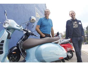 cooter enthusiast Darren Ward (left) and David Anderson of Blackfoot Motosports (right) strike a pose in front of the 70th-anniversary model Vespa.
