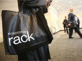 A shopper carries a bag on opening day of the new Nordstrom Rack store May 11, 2010 in New York City. The 32,000-square-foot basement discount store in Manhattan's Union Square is Nordstrom's first store in New York City.